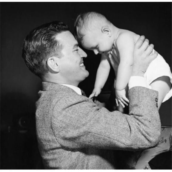 Young Man Picking Up His Baby & Smiling Poster Print - 18 x 24 in.