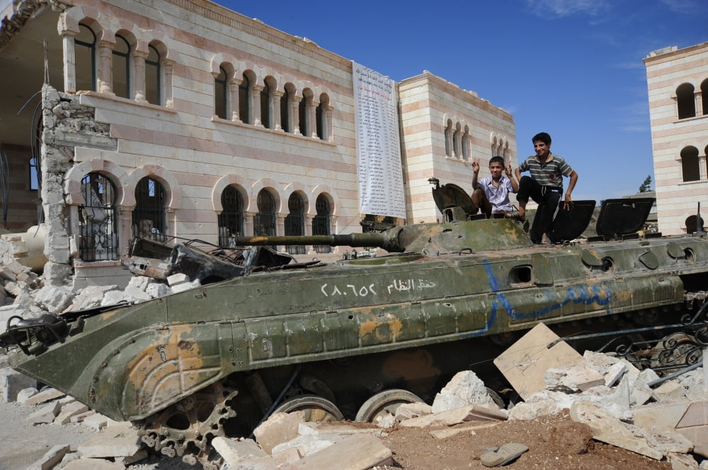Young Syrian boys on top of a demolished BMP-1 infantry fighting vehicle Canvas Art - Andrew ChittockStocktrek Images (35 x 23)