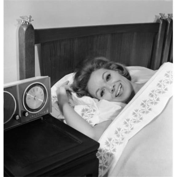 Young Woman Lying in Bed Smiling Poster Print - 18 x 24 in.