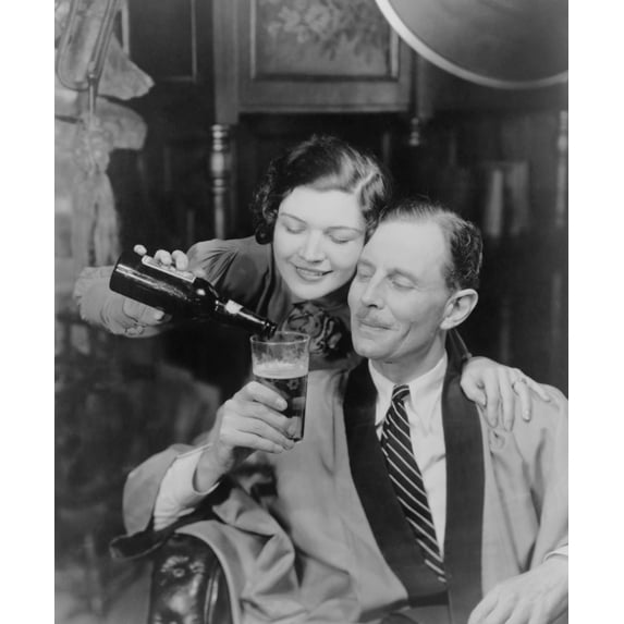 Young Woman Pouring Beer Into A Man'S Glass History (18 x 24)