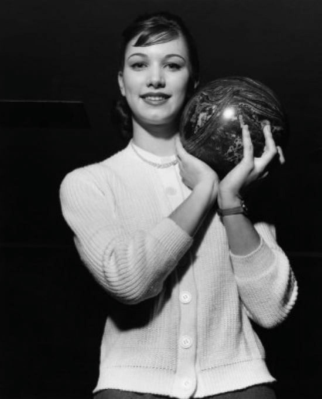 Young adult woman holding a bowling ball Canvas Art - (24 x 36)