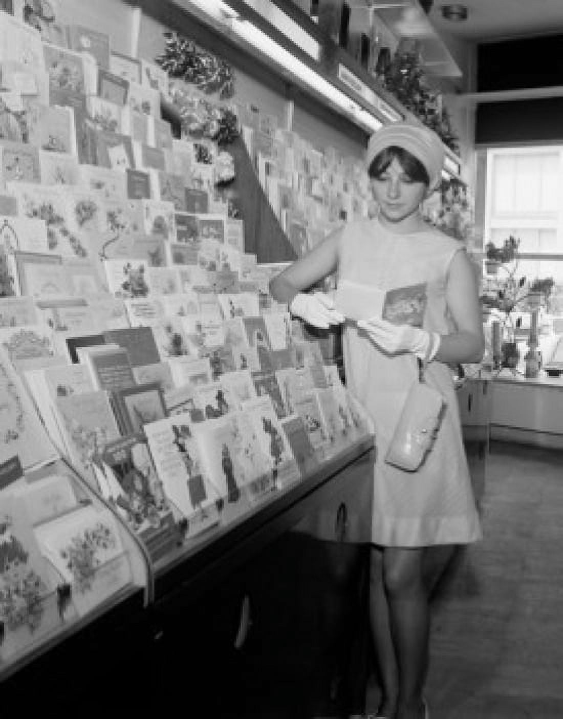 Young attractive woman picking up postcards Canvas Art - (24 x 36)
