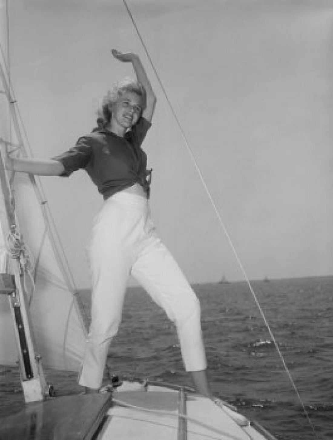 Young attractive woman weaving from yacht deck Canvas Art - (24 x 36)