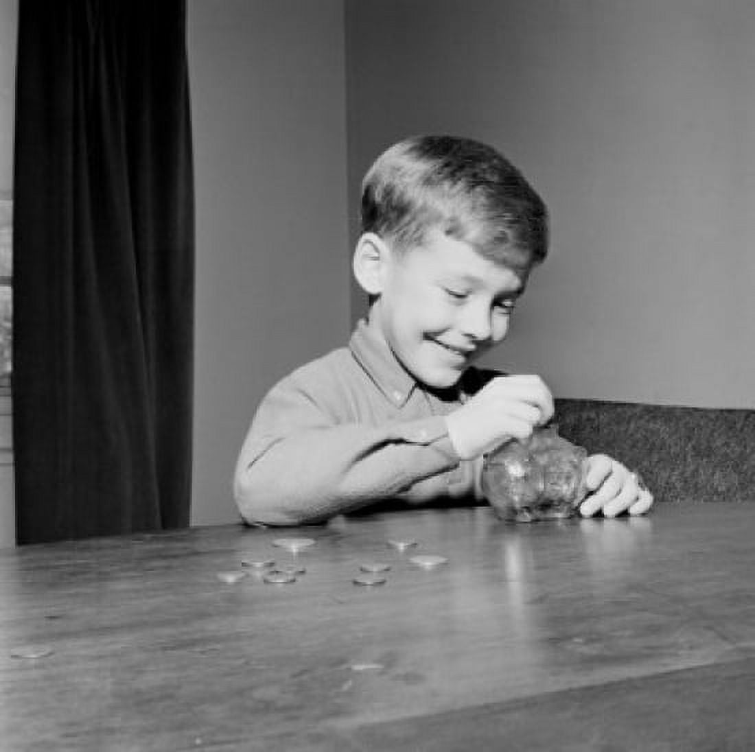 Young boy putting coins in piggybank Canvas Art - (18 x 24)
