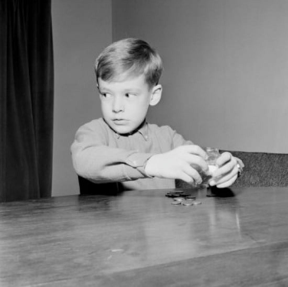 Young boy putting coins in piggybank Canvas Art - (18 x 24)