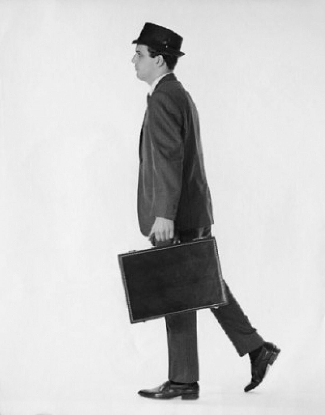 Young businessman carrying briefcase side view Canvas Art - (24 x 36)
