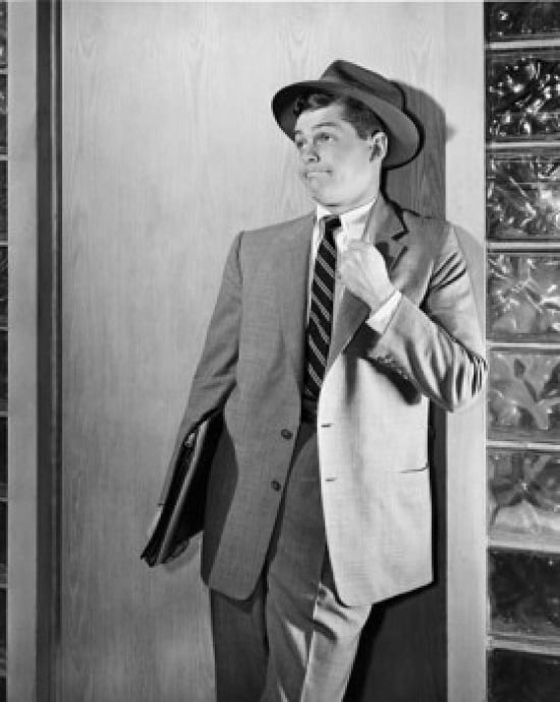 Young businessman leaning against door Canvas Art - (24 x 36)