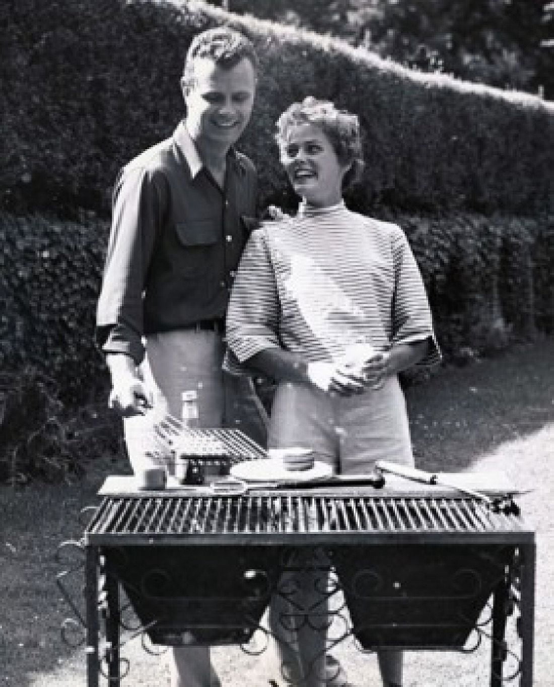 Young couple cooking on a barbecue grill Canvas Art - (24 x 36)