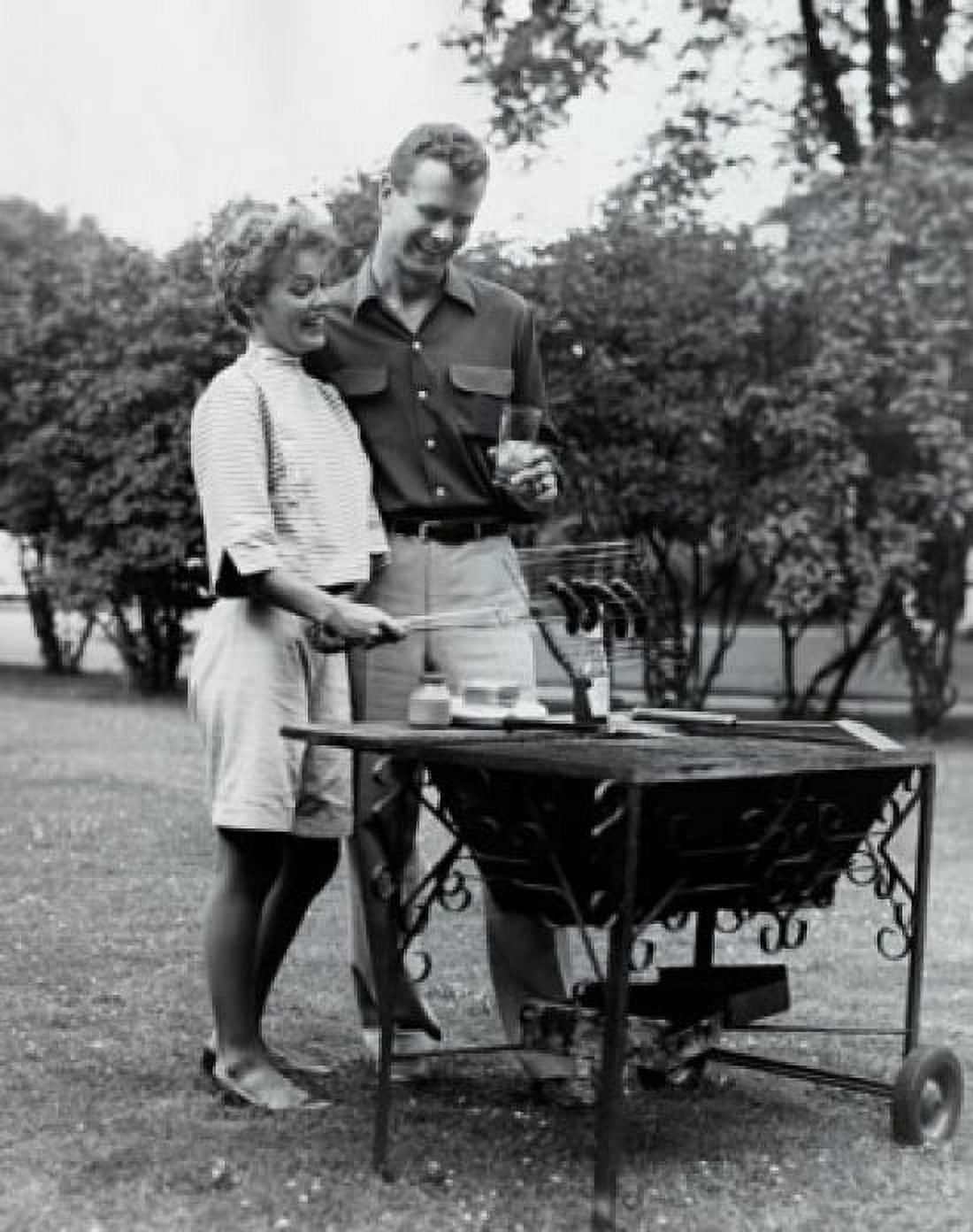 Young couple cooking sausages on a barbecue grill Canvas Art - (18 x 24)