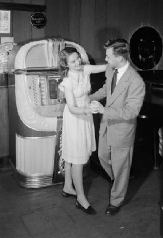 Young couple dancing by jukebox in bar Canvas Art - (18 x 24)