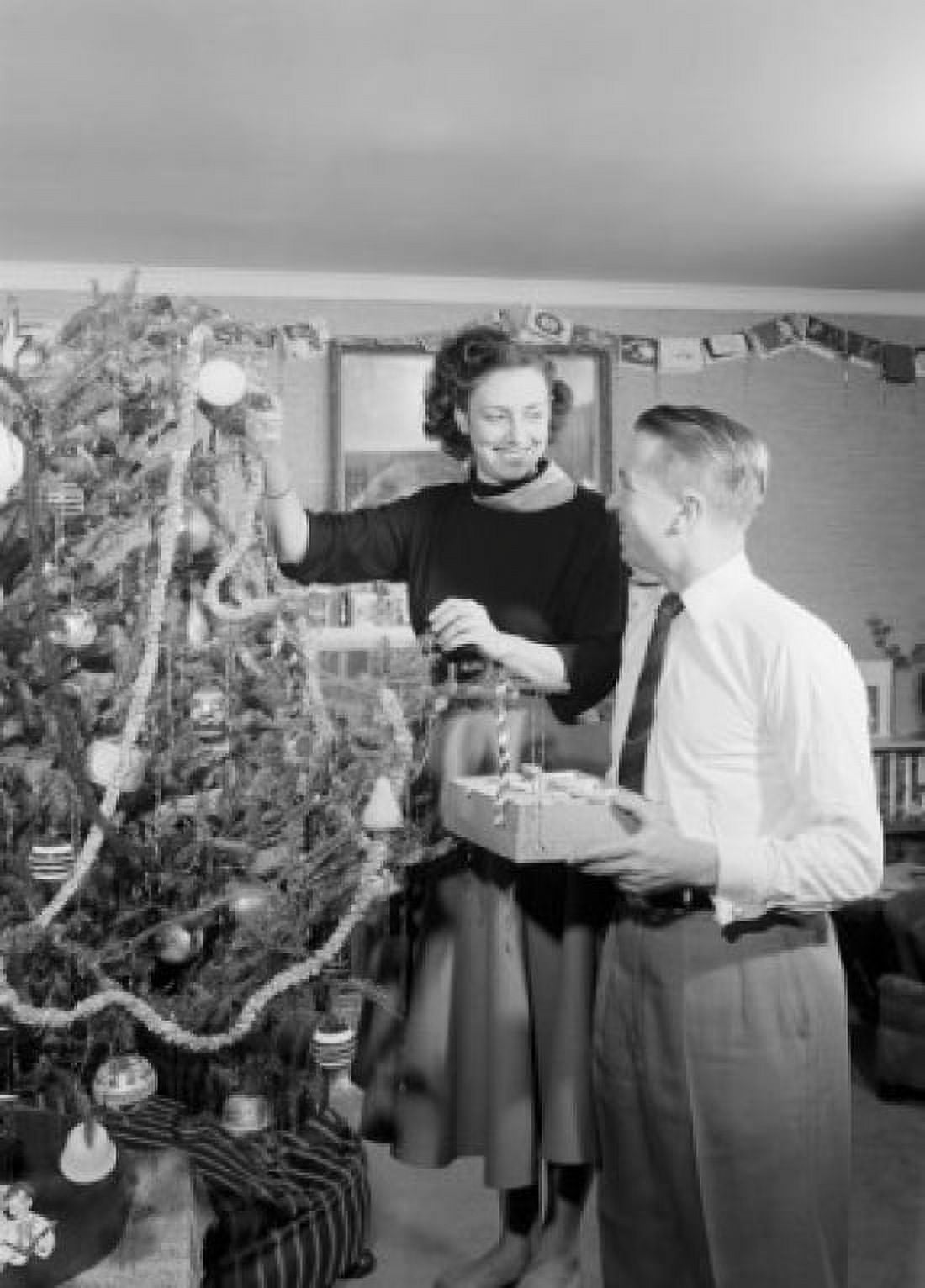 Young couple decorating christmas tree Canvas Art - (24 x 36)