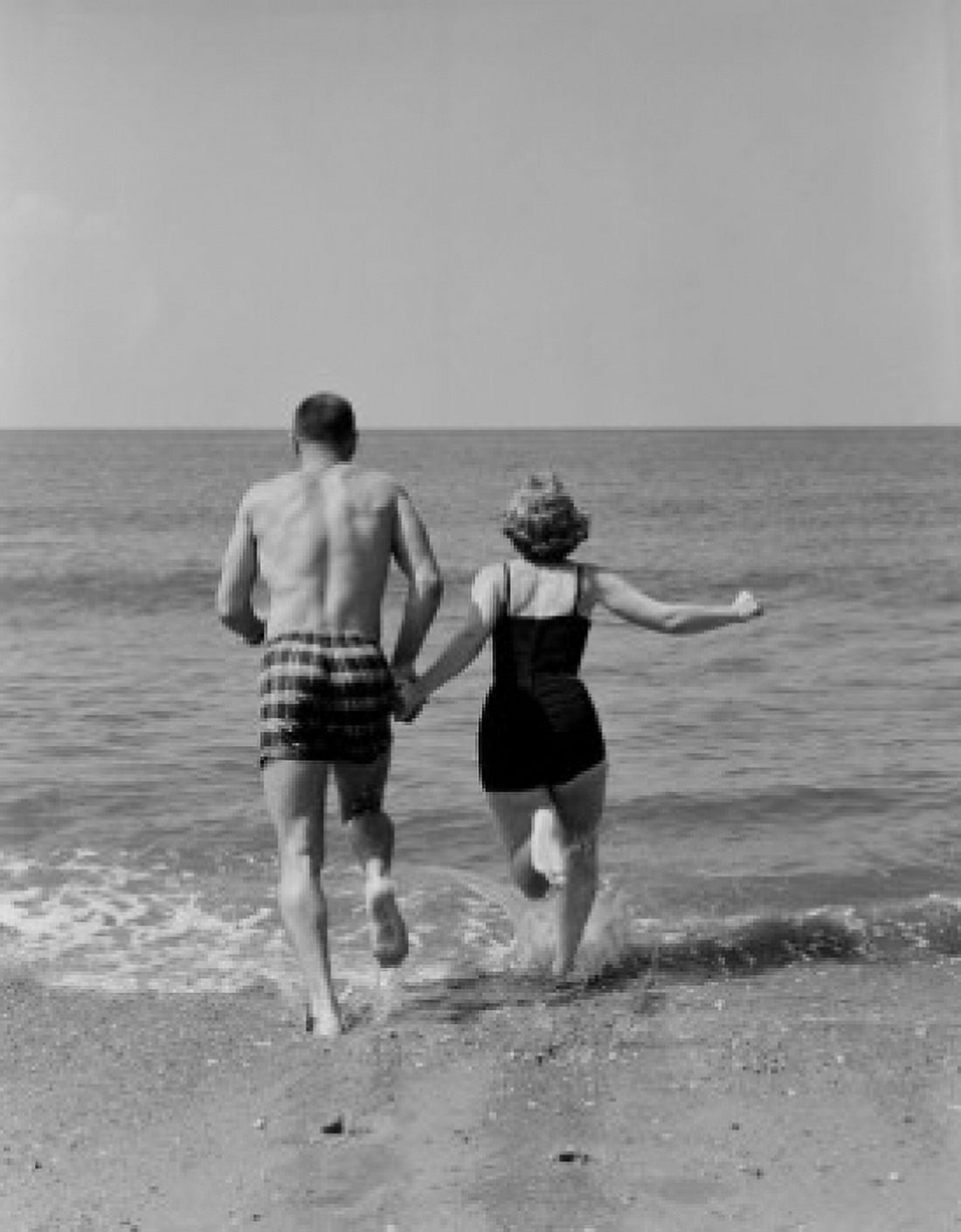 Young couple holding hands and running into sea Canvas Art - (18 x 24)