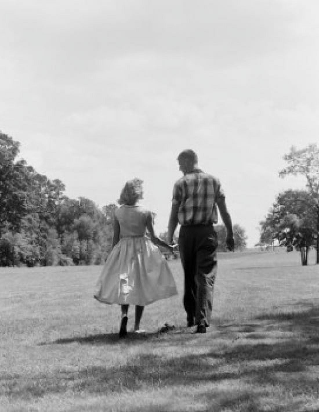 Young couple holding hands and walking Canvas Art - (24 x 36)