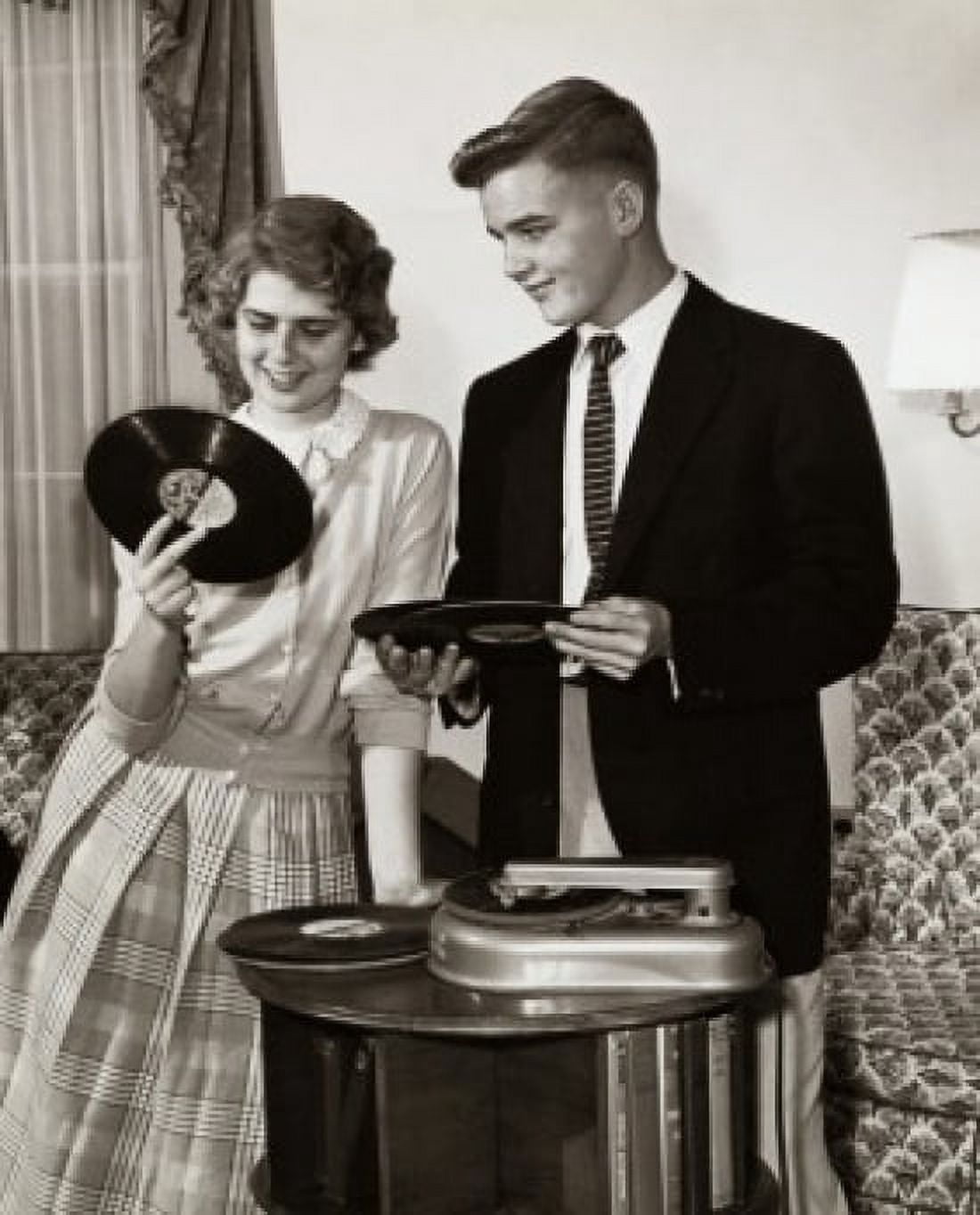 Young couple holding records near turntable Canvas Art - (18 x 24)