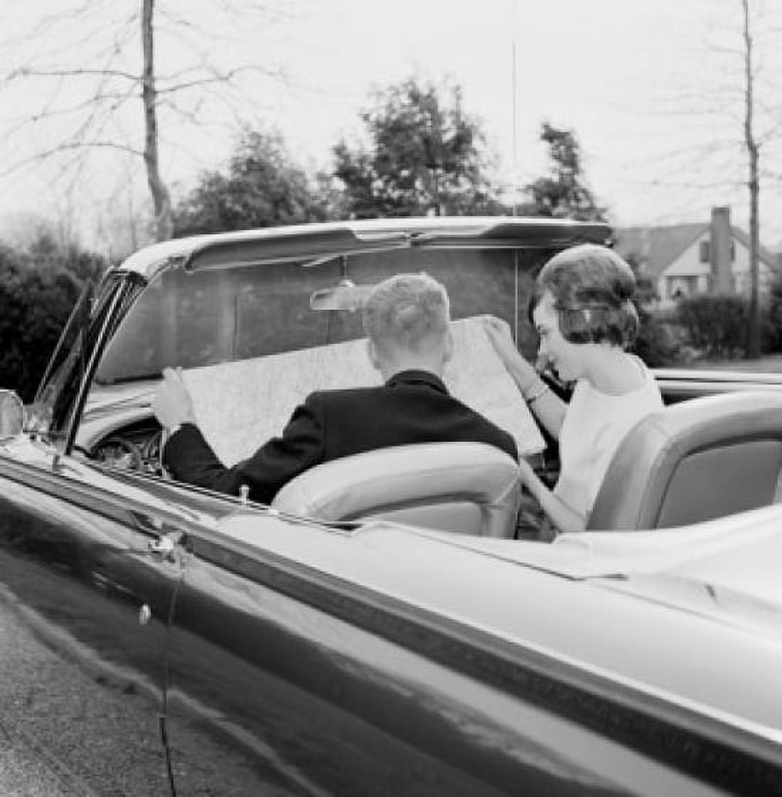 Young couple in convertible car reading map Canvas Art - (24 x 36)