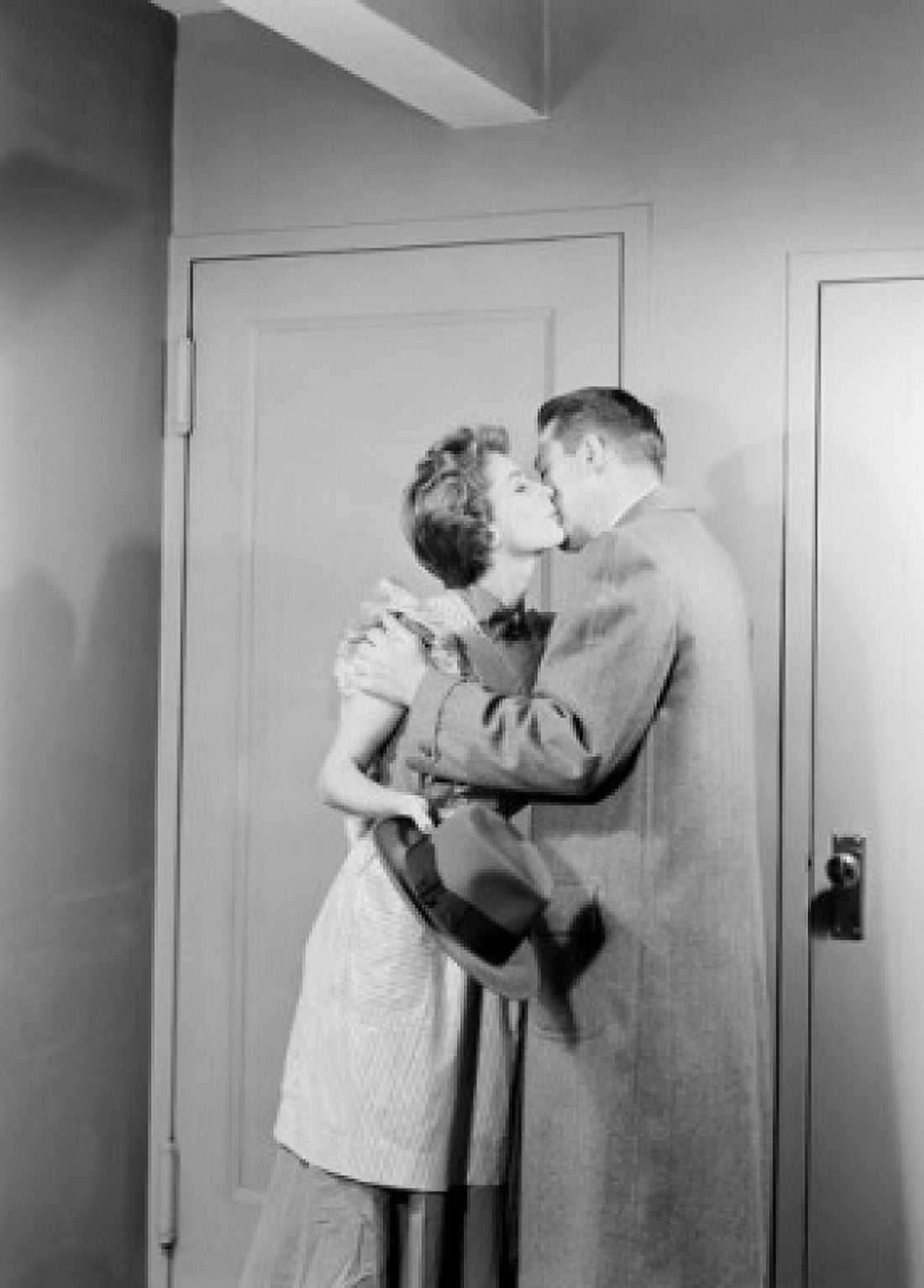 Young couple kissing for goodbay in front of apartment door Canvas Art - (18 x 24)