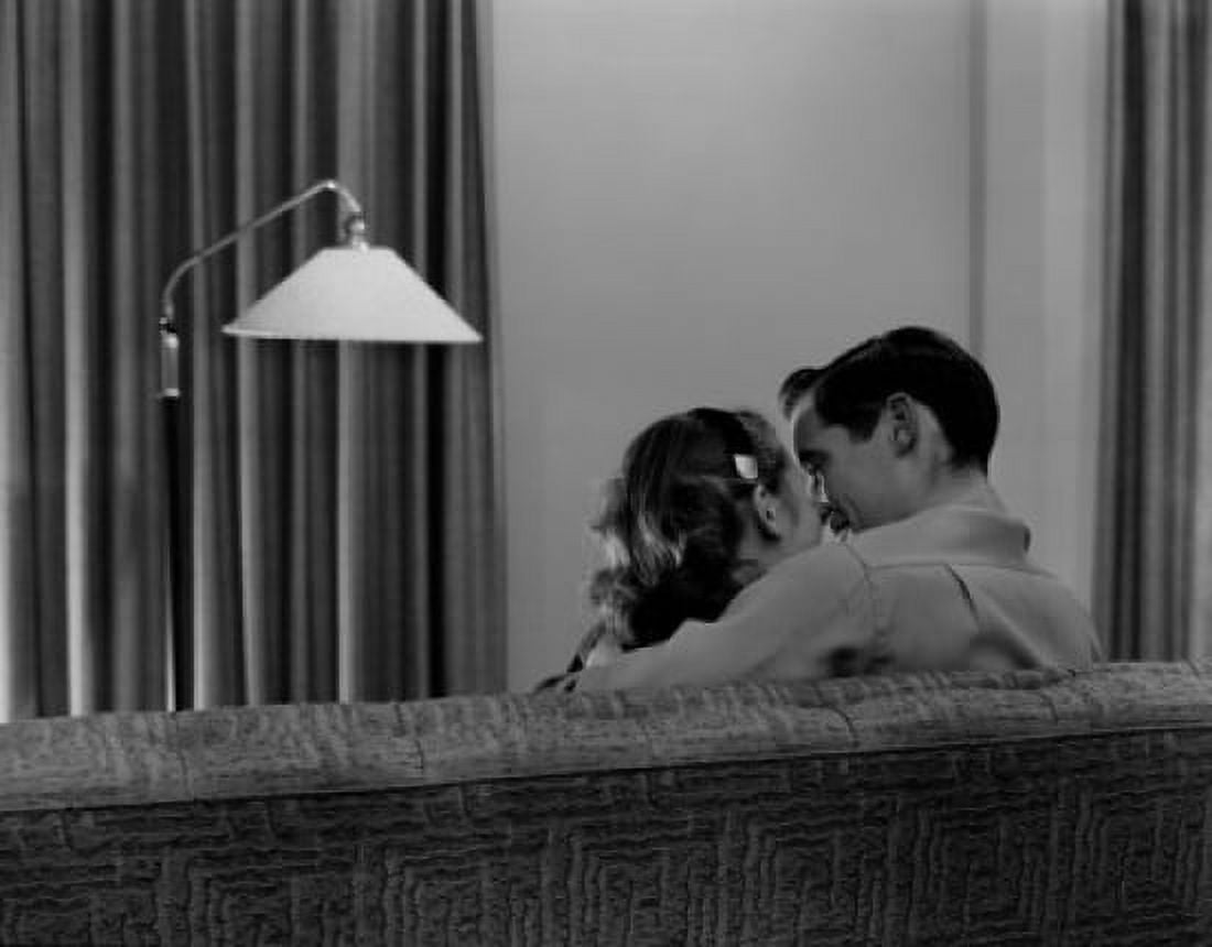 Young couple kissing on sofa rear view Canvas Art - (24 x 36)