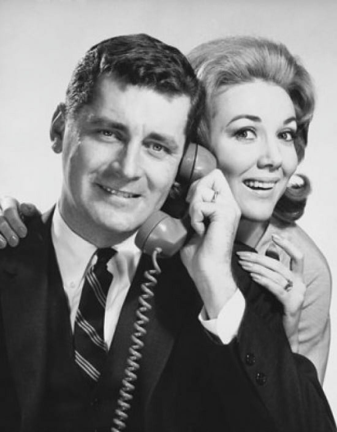 Young couple listening on the telephone Canvas Art - (24 x 36)