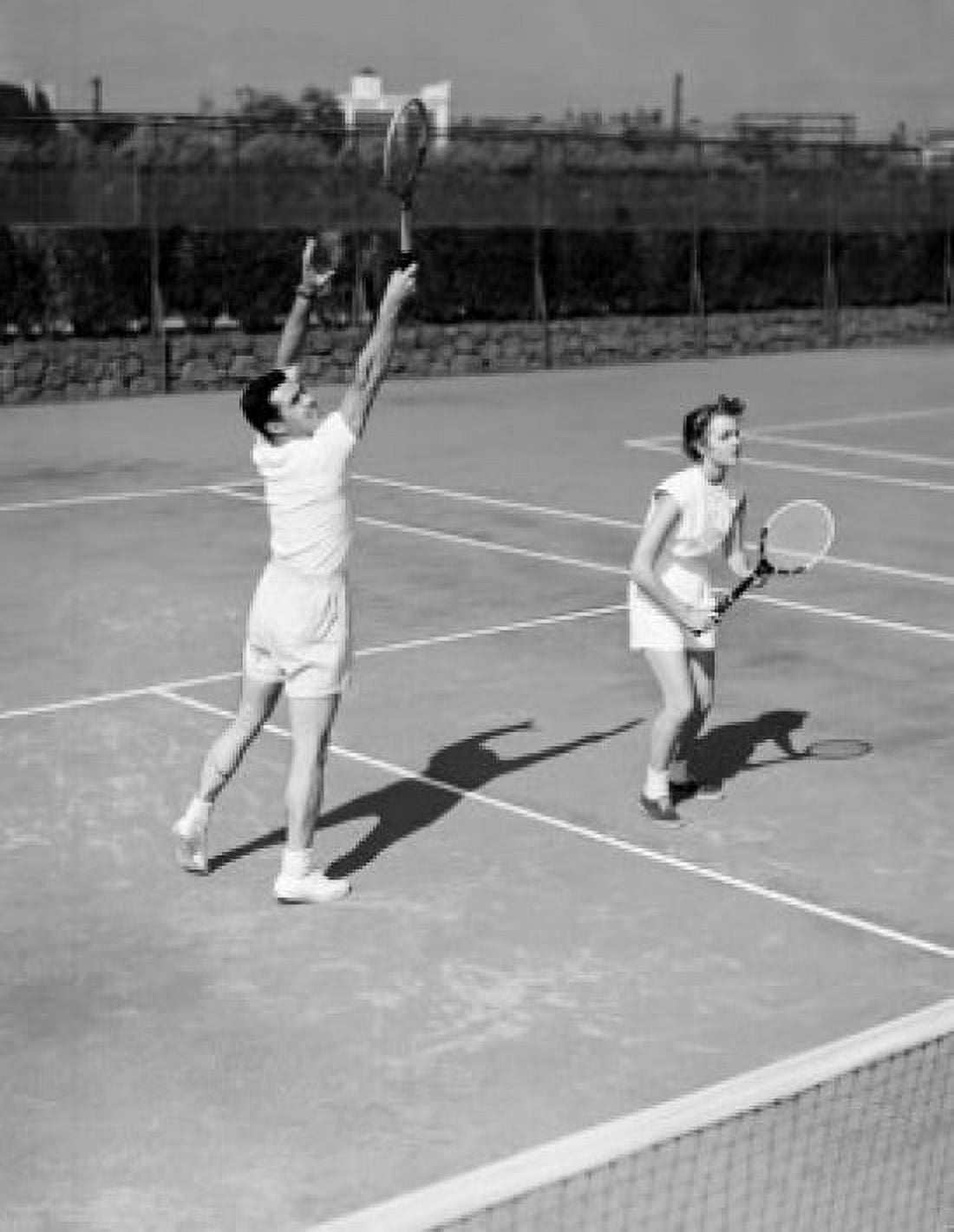 Young couple playing doubles tennis Canvas Art -  (24 x 36)