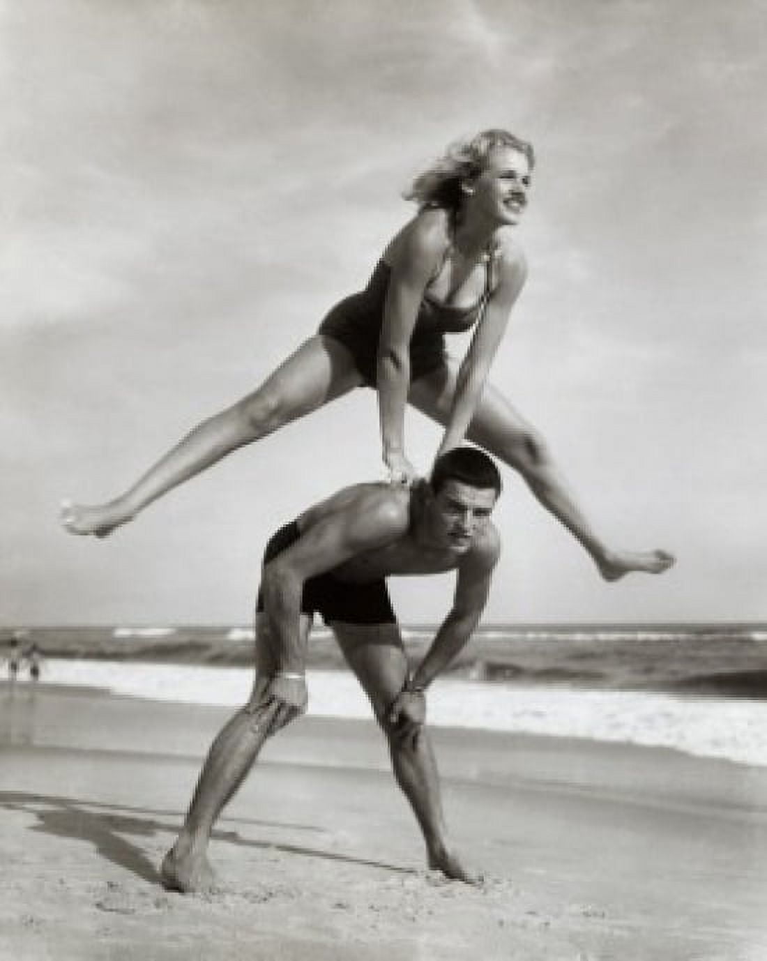 Young couple playing leapfrog on the beach Canvas Art - (18 x 24)
