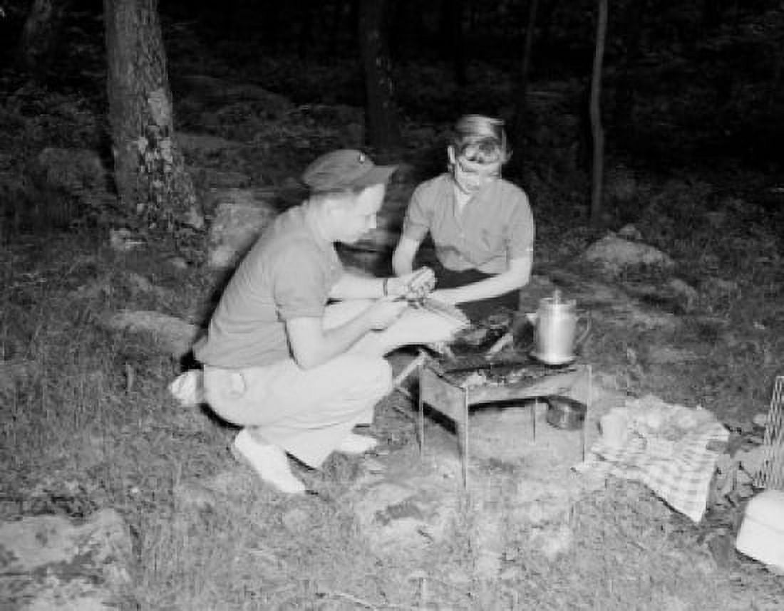 Young couple preparing food and drink on barbecue grill Canvas Art - (24 x 36)