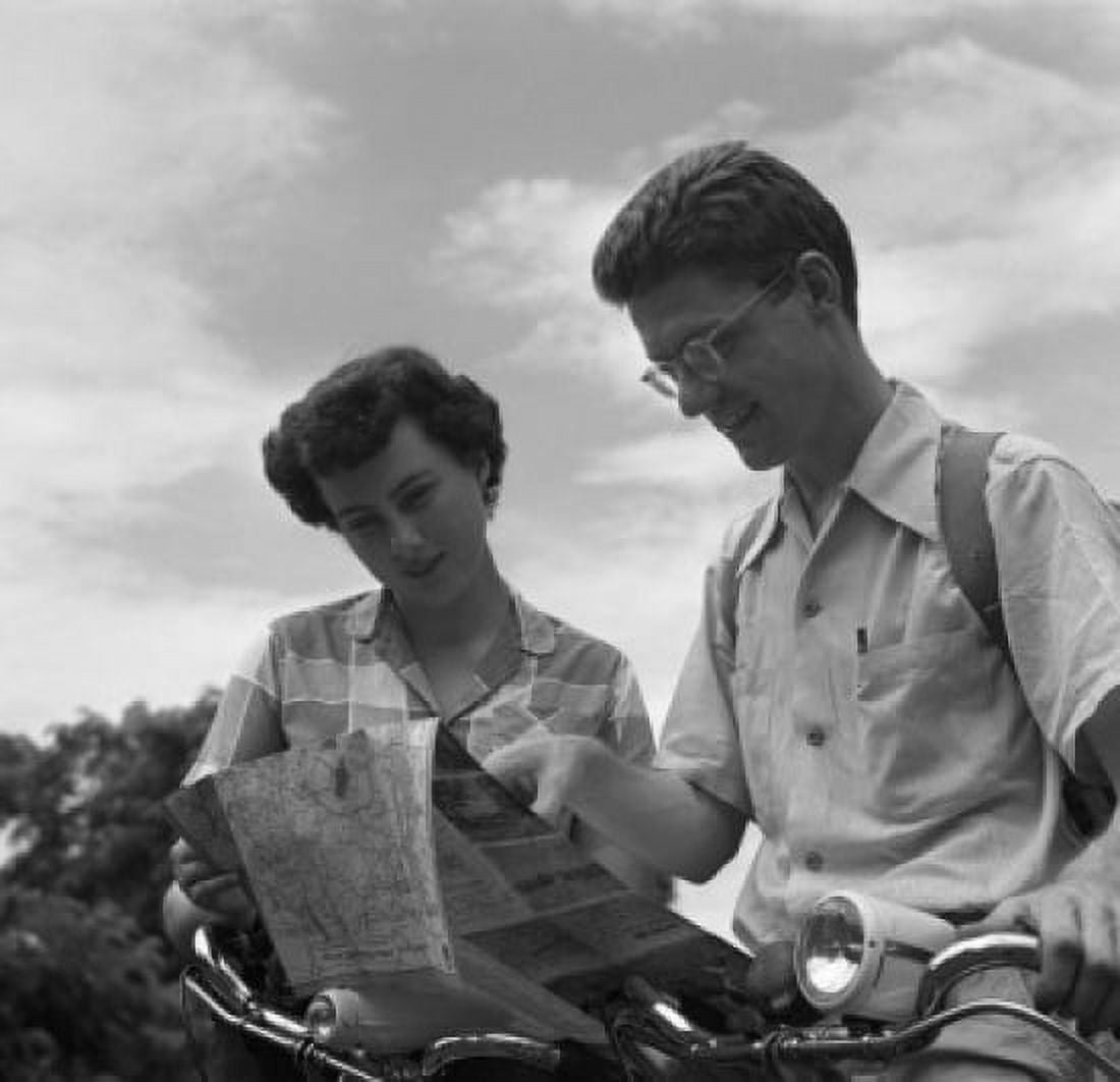 Young couple reading map Canvas Art - (24 x 36)