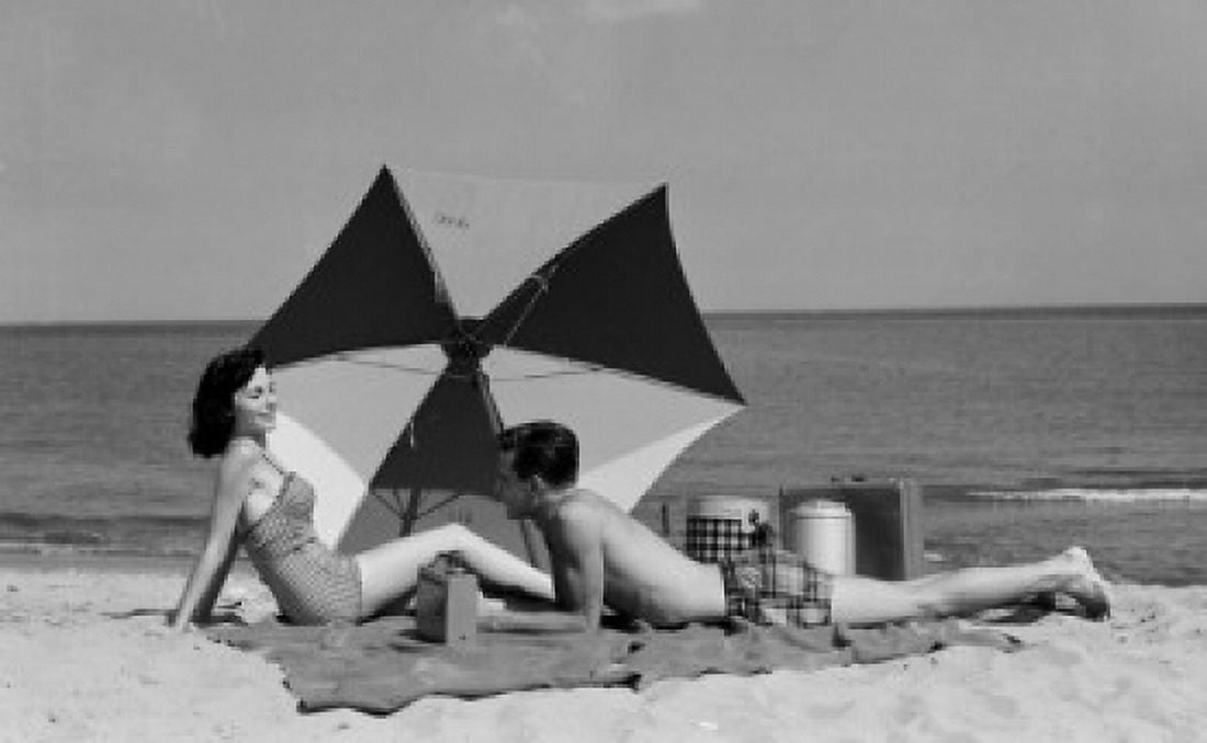 Young couple relaxing on the beach Canvas Art - (24 x 36)