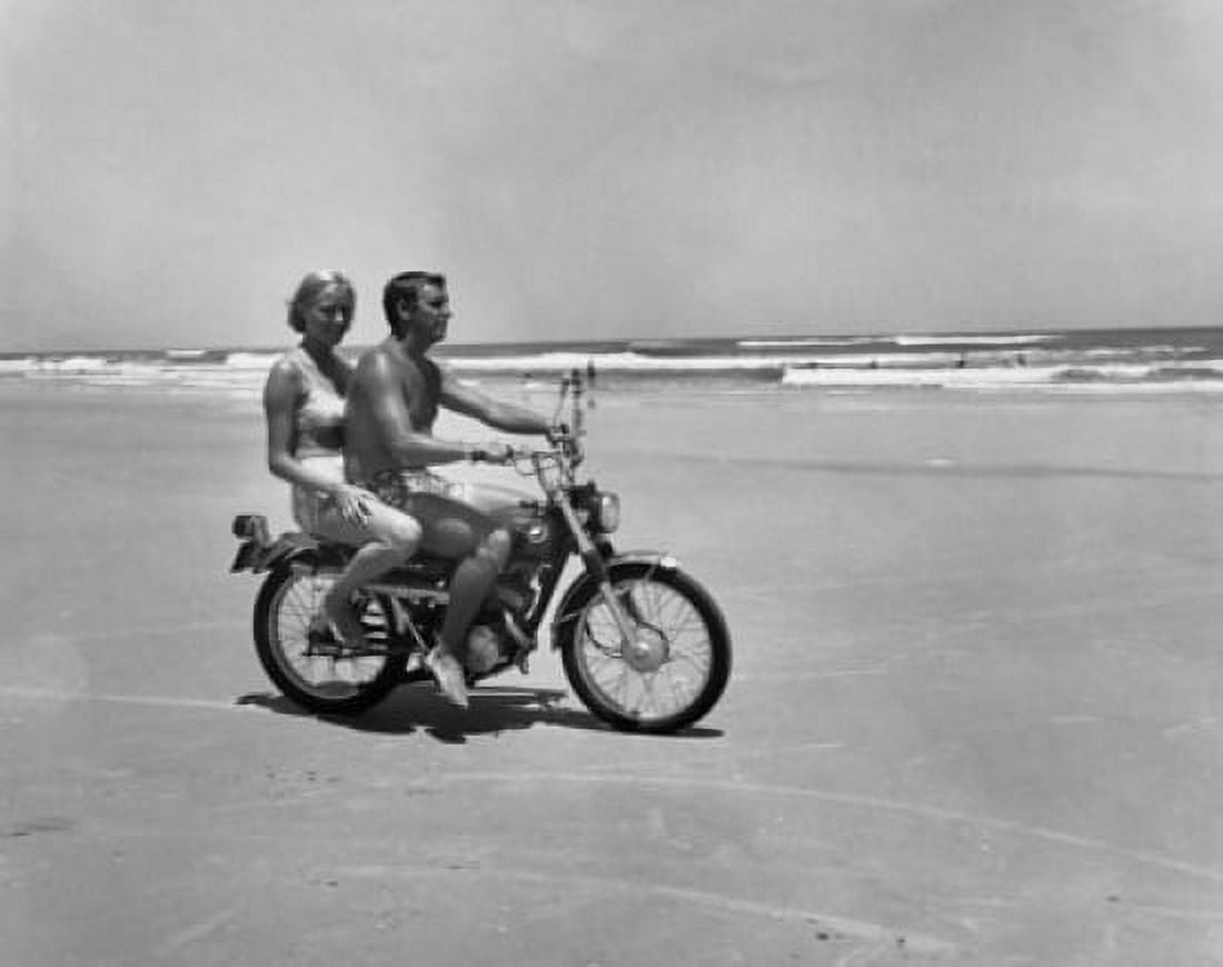 Young couple riding motorcycle on beach Canvas Art - (18 x 24)