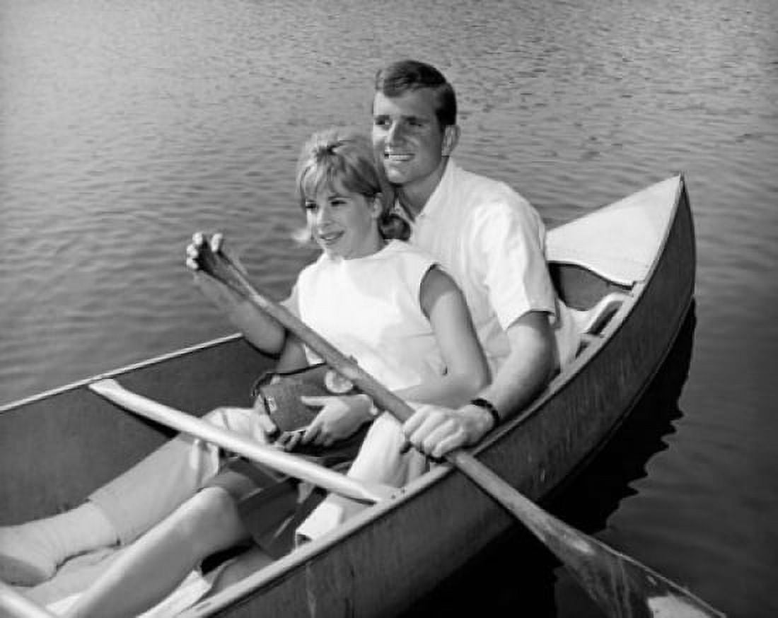 Young couple rowing rowboat and smiling Canvas Art - (18 x 24)