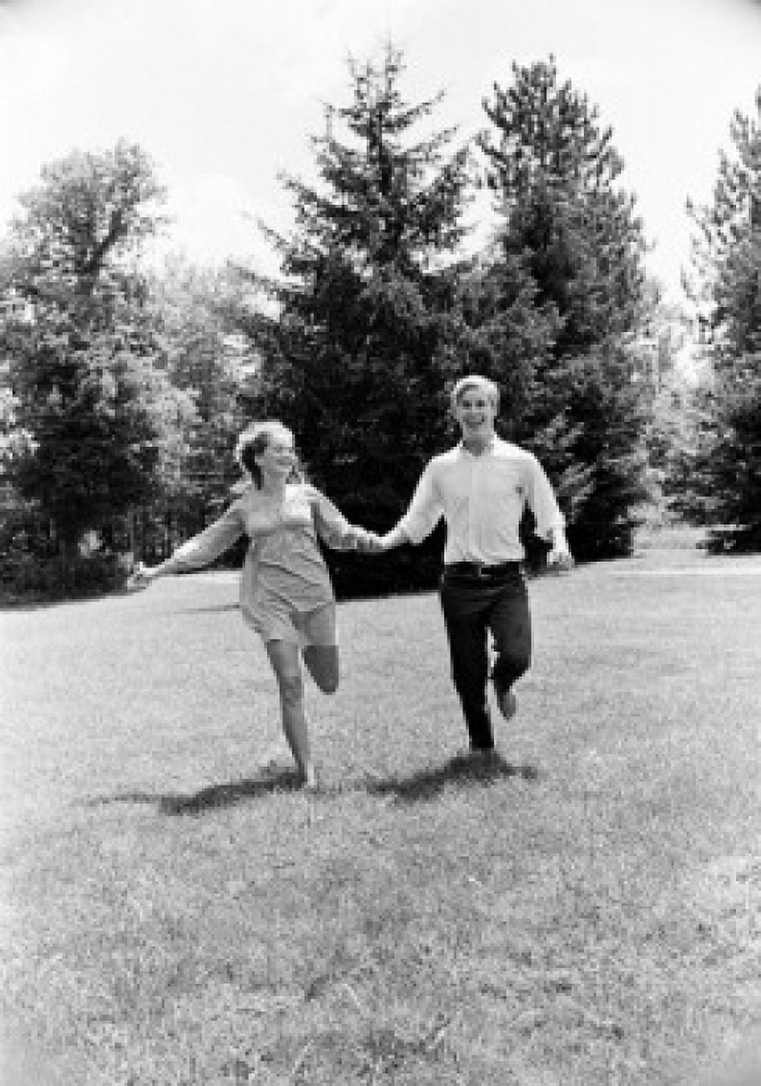 Young couple running in forest Canvas Art -  (18 x 24)