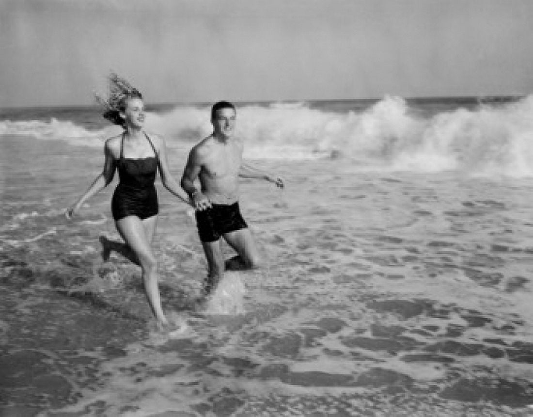 Young couple running in sea Canvas Art - (18 x 24)