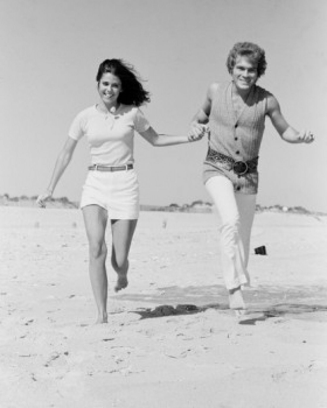 Young couple running on beach Canvas Art - (18 x 24)