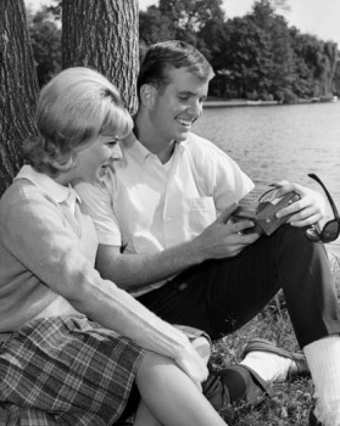 Young couple sitting at side of pond Canvas Art -  (24 x 36)