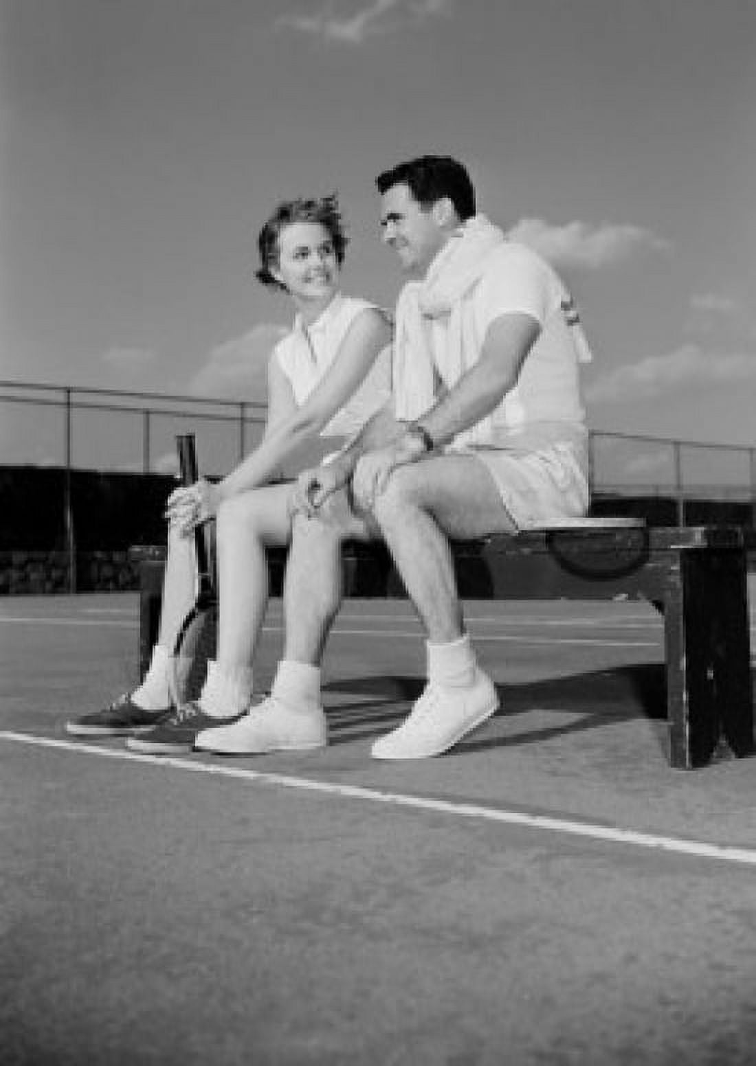 Young couple sitting by tennis court Canvas Art - (24 x 36)