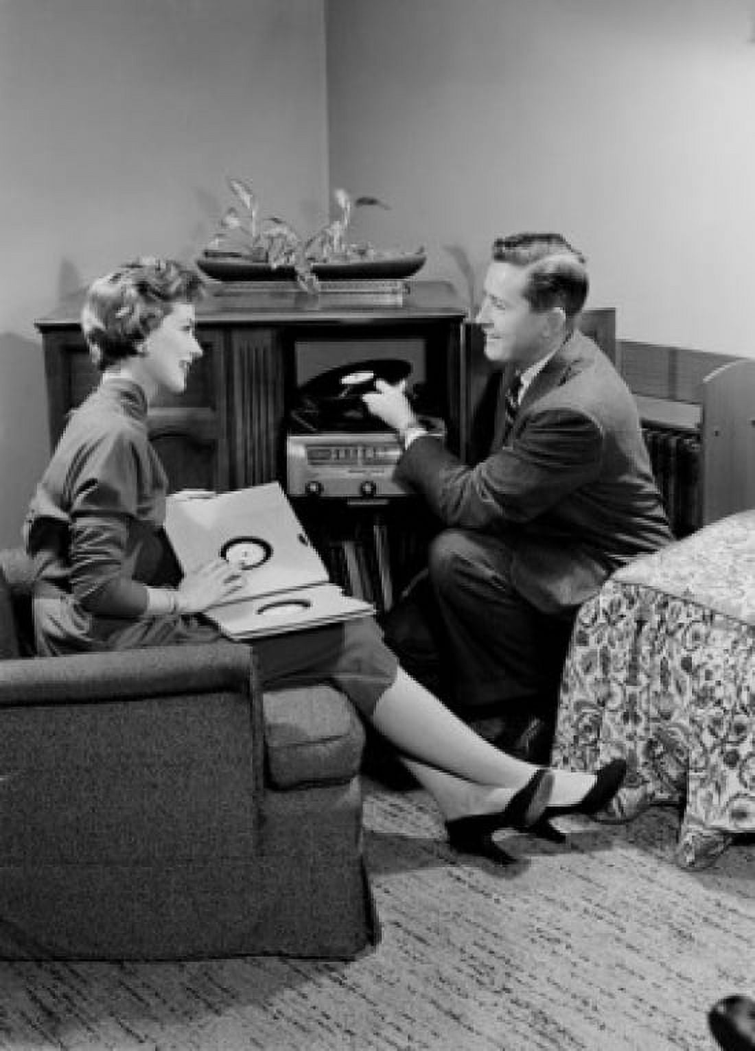 Young couple sitting in living room and listening to music Canvas Art - (18 x 24)