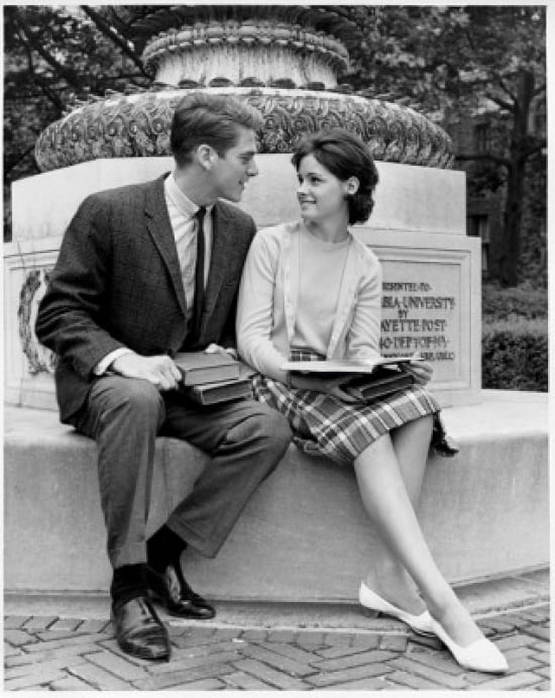 Young couple sitting on a pedestal looking at each other Canvas Art - (18 x 24)