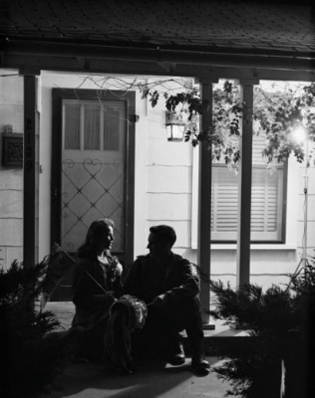 Young couple sitting on porch at night Canvas Art - (24 x 36)