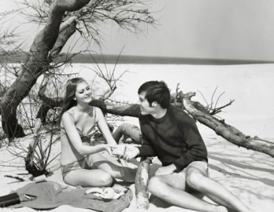 Young couple sitting on the beach Canvas Art - (24 x 36)