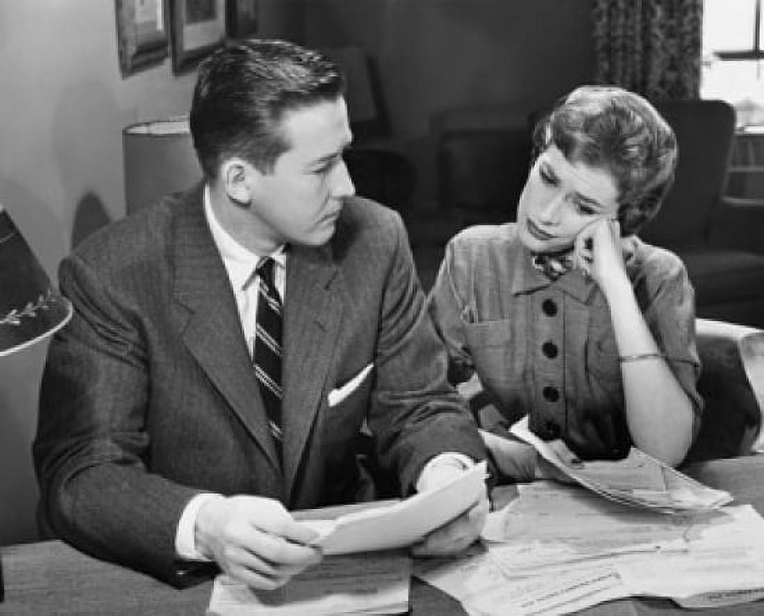Young couple sitting together and holding bills Canvas Art - (24 x 36)