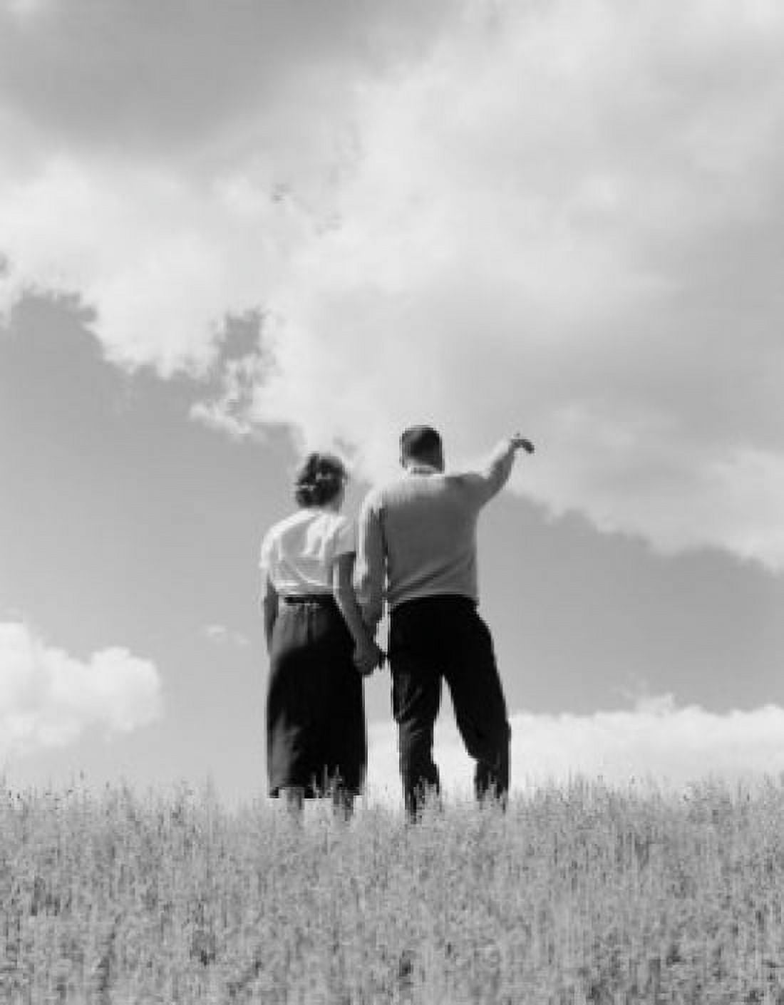 Young couple standing and holding hands rear view Canvas Art - (24 x 36)