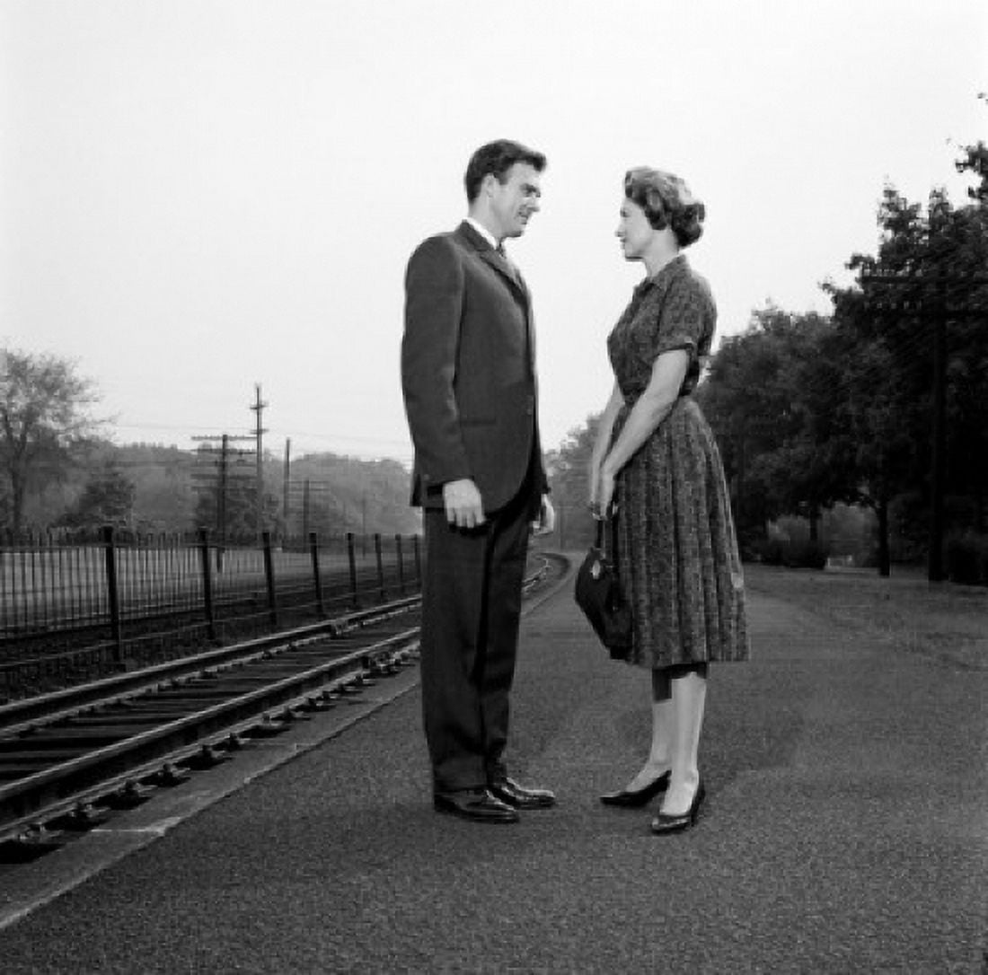 Young couple standing at train station Canvas Art - (18 x 24)