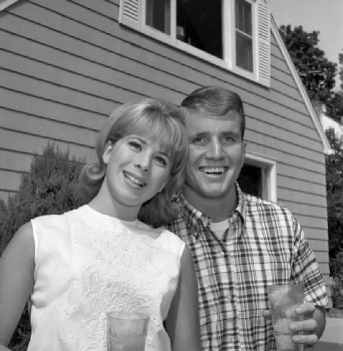 Young couple standing in front of house Canvas Art - (18 x 24)