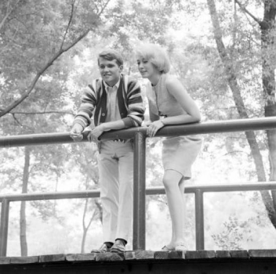 Young couple standing on footbridge Canvas Art - (24 x 36)