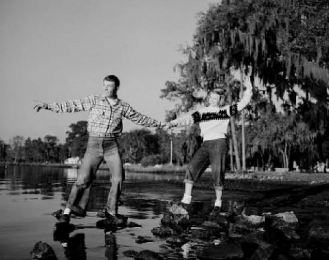 Young couple standing on pebble at lakeshore Canvas Art - (24 x 36)