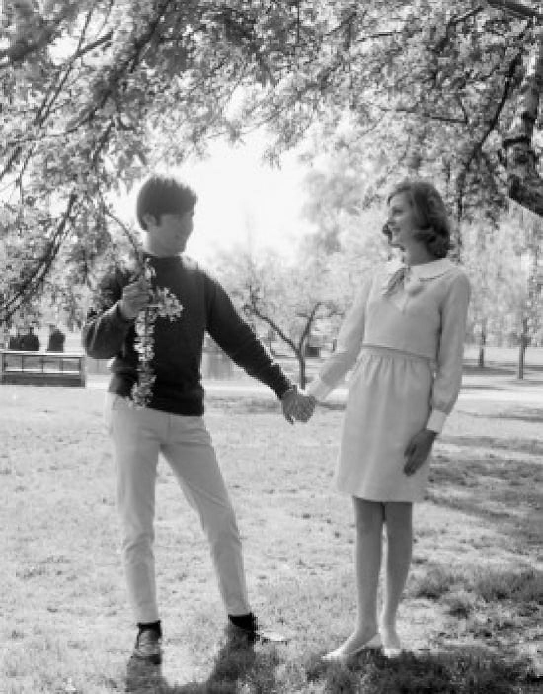 Young couple standing under tree holding hands Canvas Art - (18 x 24)