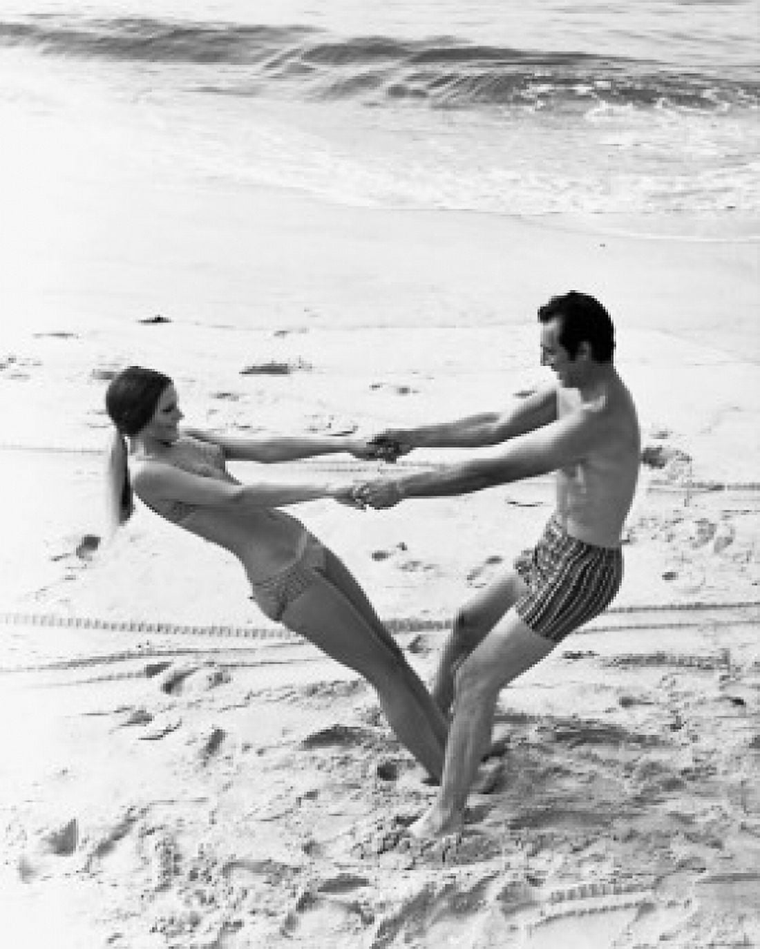 Young couple swinging each other on the beach Canvas Art - (18 x 24)