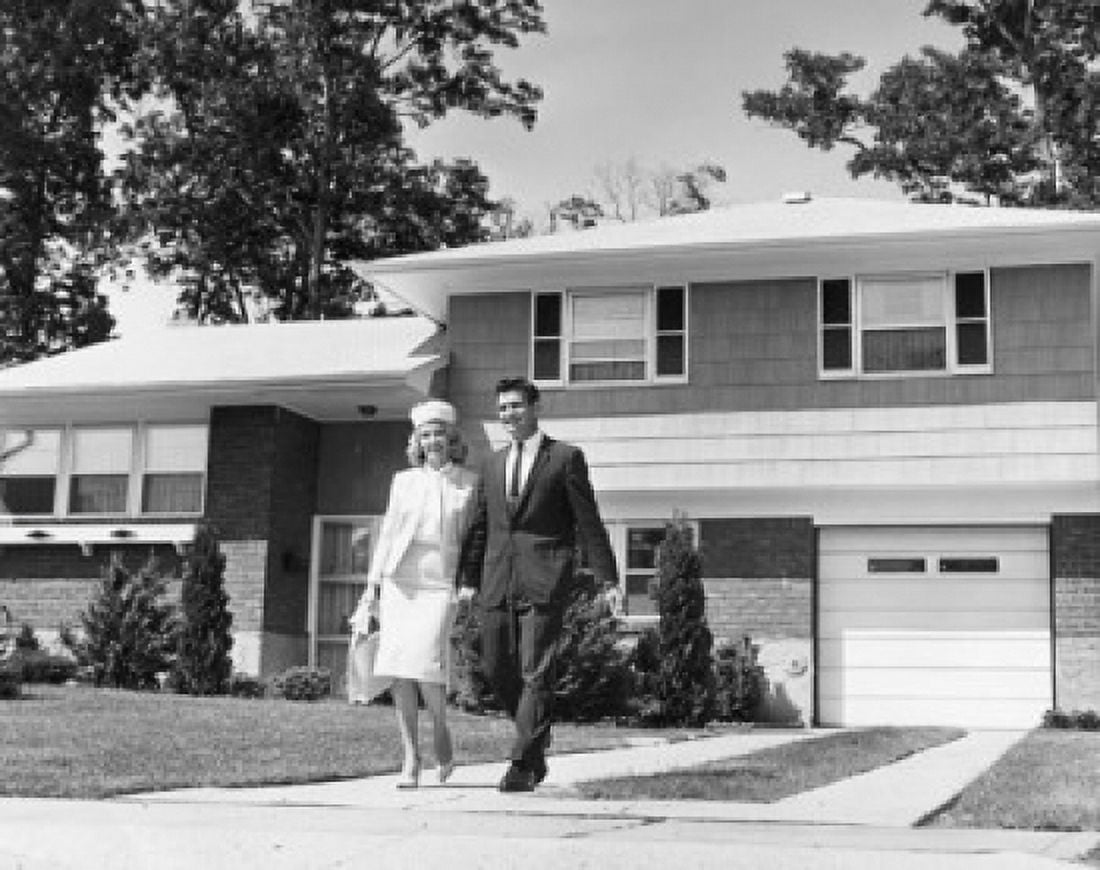 Young couple walking across front yard outside house Canvas Art - (18 x 24)