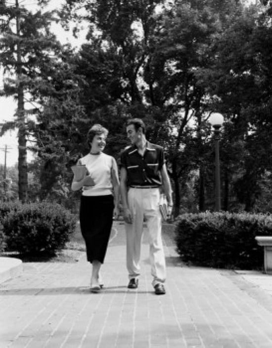 Young couple walking and talking Canvas Art - (18 x 24)