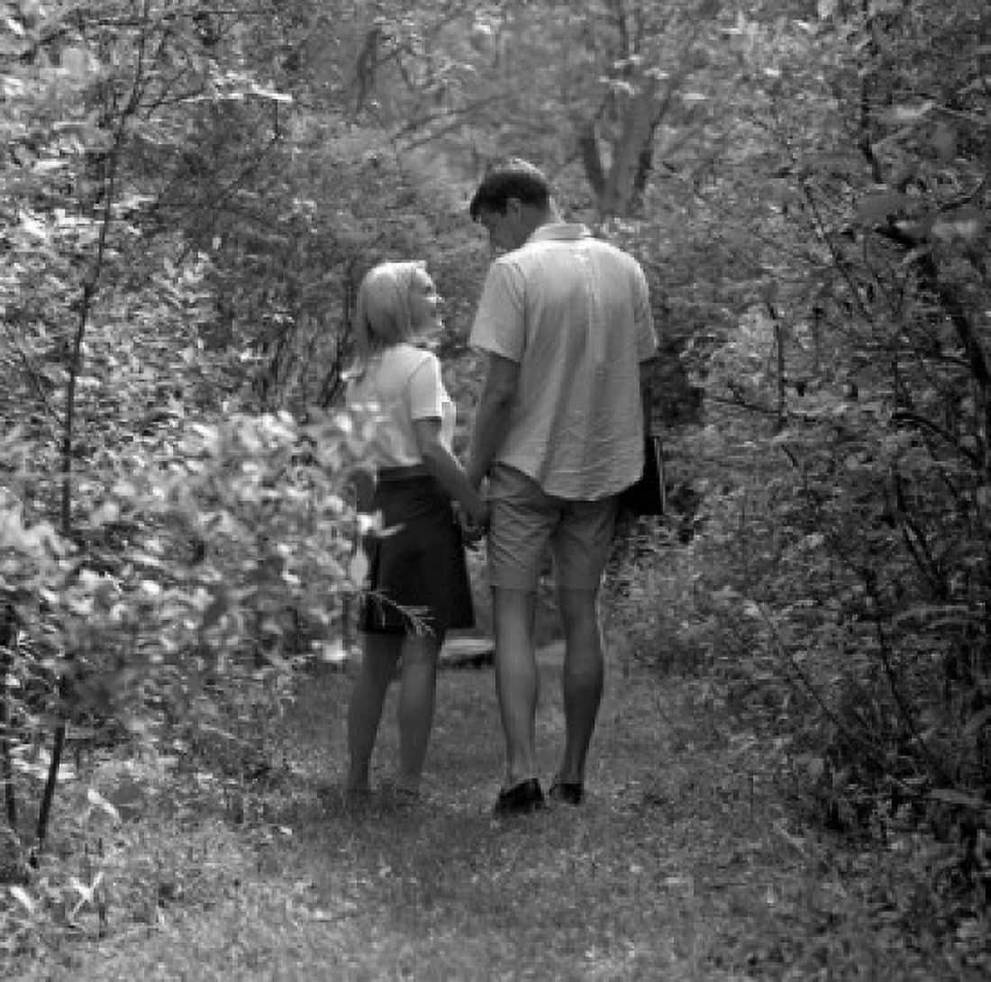 Young couple walking in forest Canvas Art - (24 x 36)