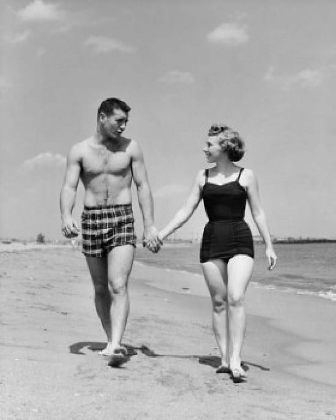 Young couple walking on beach Canvas Art - (18 x 24)